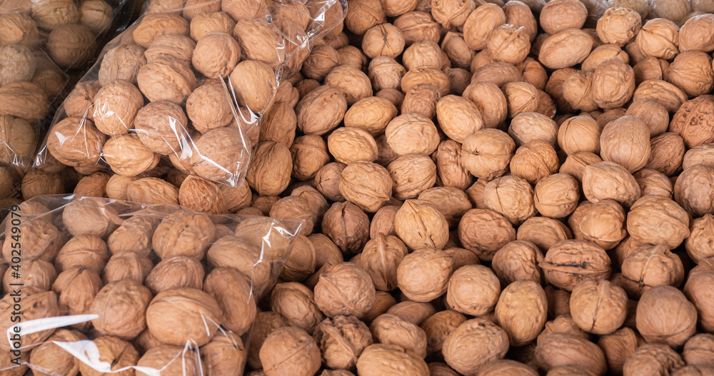 Large amount of fresh walnuts in the market for sale. Large amount of fresh walnuts in the market for sale.