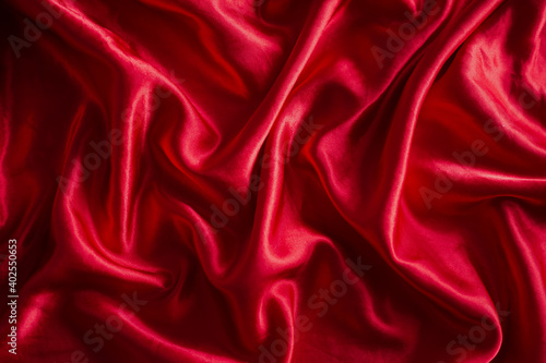 Luxurious satin red silk or fabric. soft waves cloth abstract background.