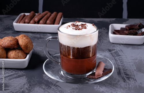 Bicerin, layered Italian coffee drink with chocolate and whipped cream in the glass