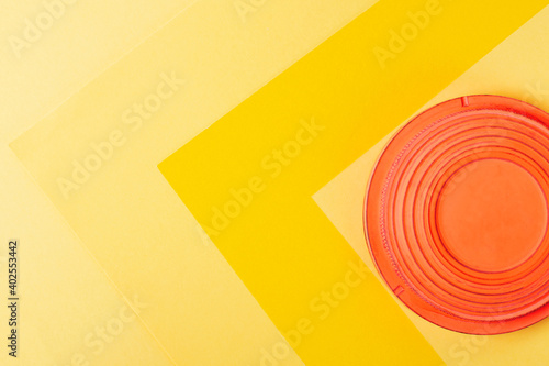 Clay target for skeet shooting against the colorful yellow background. Clay pigeon shooting. Copy space