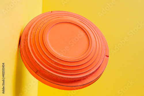 Clay disc target for skeet shooting flying against the colorful yellow background. Clay pigeon shooting photo