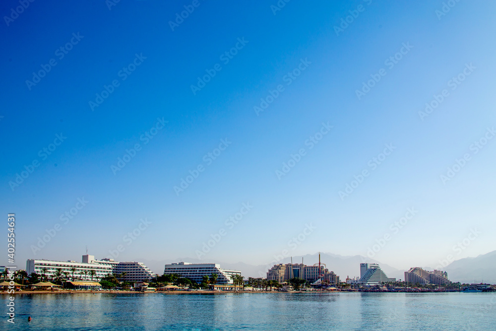 Eilat, Israel - Oktober 23, 2020: Panoramic view of the central public beach of Eilat - the famous resort city of Israel Eilat, Israel - Oktober 23, 2020: Panoramic view of the central public beach of Eilat - the famous resort city of Israel