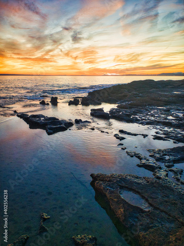 sunset at the spanish beach with rocks