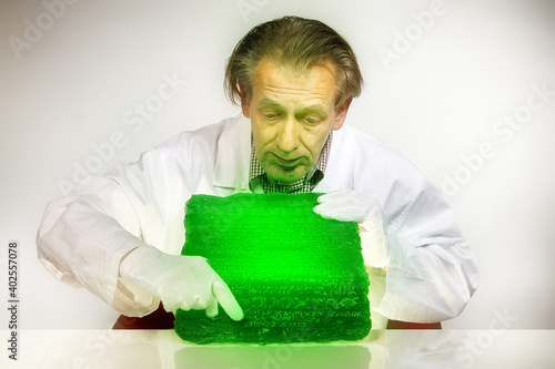 Museologist examining artifact of emerald tablet on his workplace photo