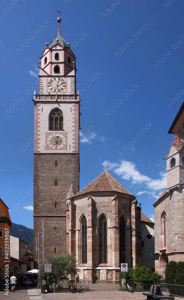 Gothic St Nikolaus church with apse and bell tower in the old medieval town of Merano in South Tyrol, Italy