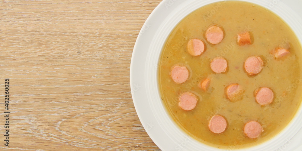 fresh potato soup with viennese sausages on a wooden board fresh potato soup with viennese sausages on a wooden board