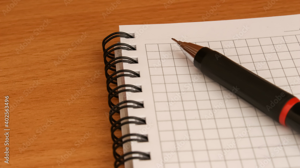 Pen and notepad on wooden desk. Education concept. Pen and notepad on wooden desk. Education concept.