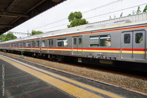 Commuter Line (train) arrives at a station railway station, Jakarta.