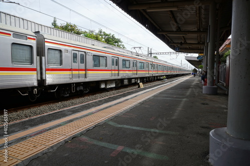 Commuter Line (train) arrives at a station railway station, Jakarta.