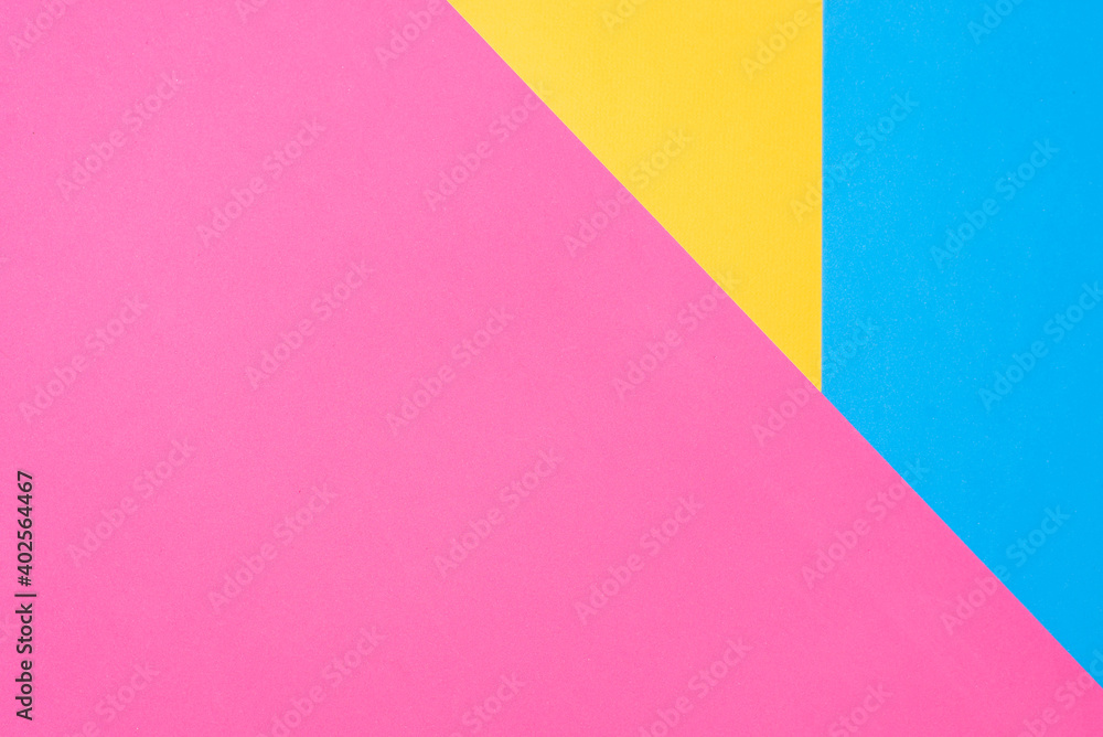 Multicolored paper background. Yellow pink and blue geometric backdrop.