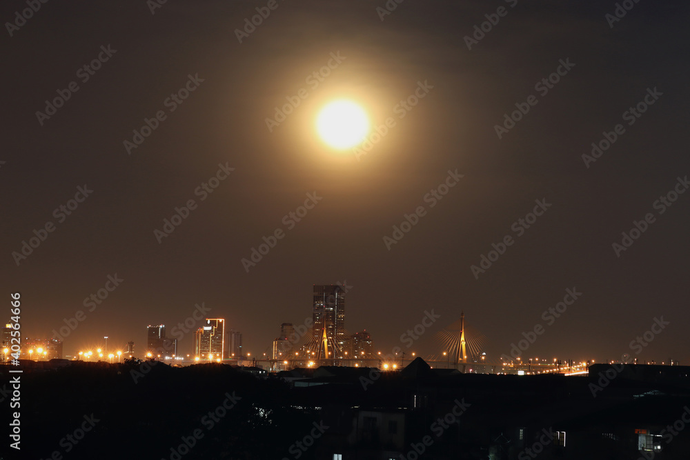 Night city lights with skyscraper building architecture, skyline horizon cityscape downtown night scene at full moon night