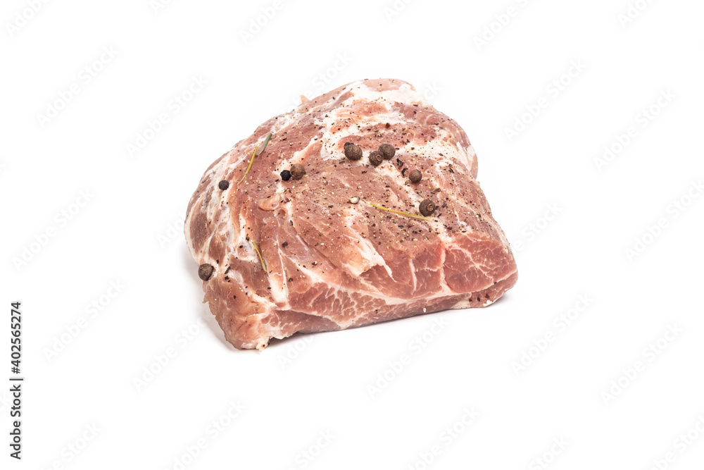 studio lighting. meat of a neck part of pork on a wooden cutting Board. On it seasoning, pepper. white background. Close-up studio lighting. meat of a neck part of pork on a wooden cutting Board. On it seasoning, pepper. white background. Close-up