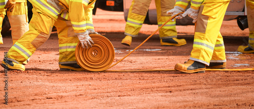 Action of fireman and recue team are preparing water hydrant hose for fire fighting emergency case. photo