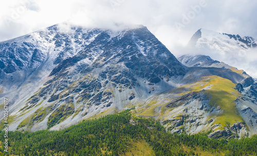 closeup mountain in a snow and dense clouds