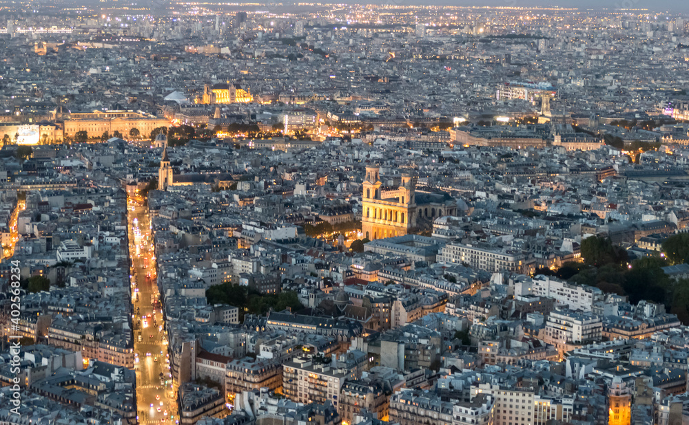 Aerial view of Paris at twilight with the city illuminated