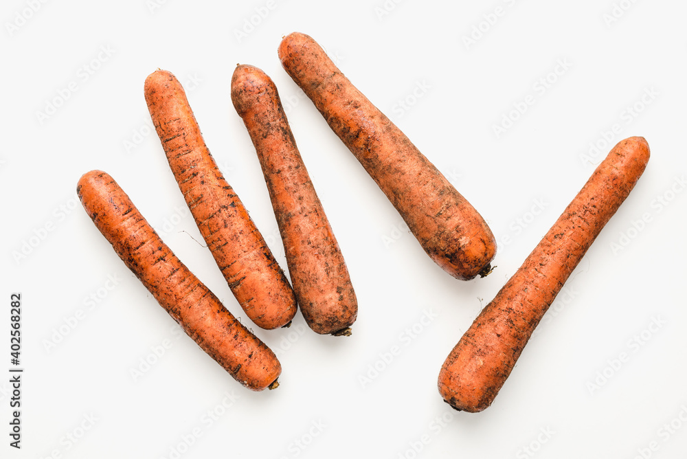 carrots on white background, unwashed carrots