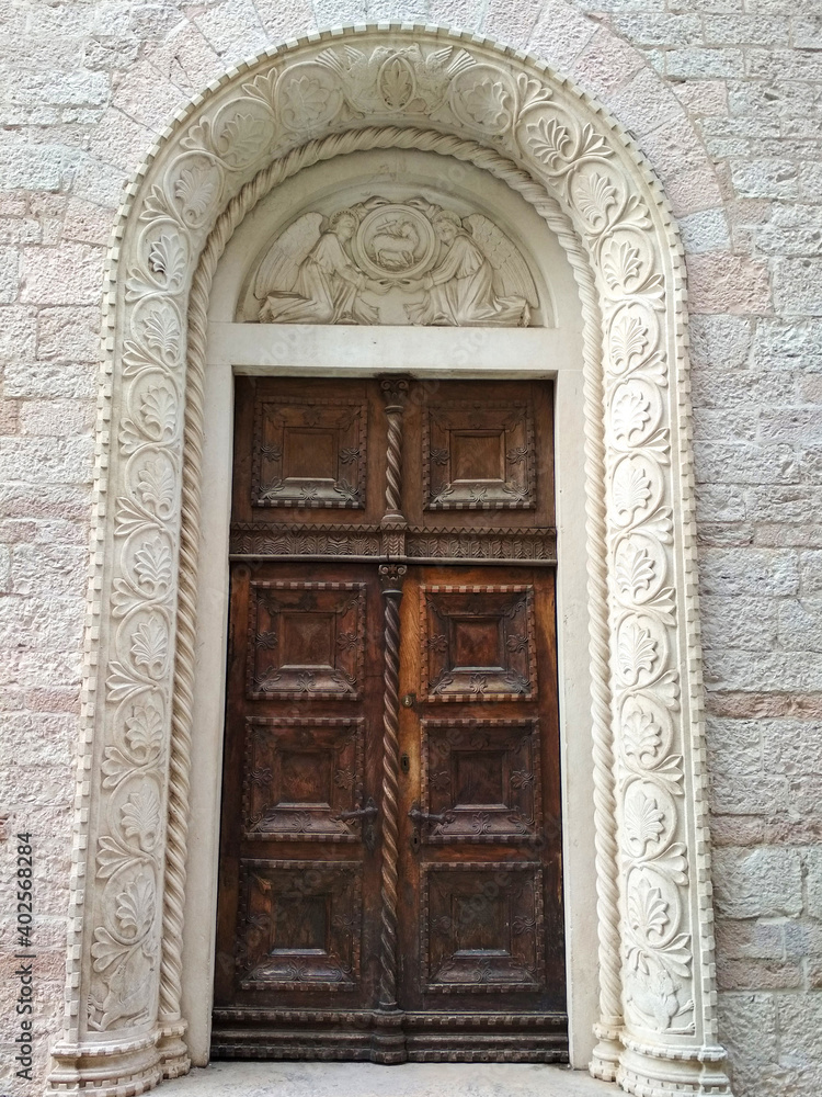 Fragment of a building with a door decorated with bas reliefs