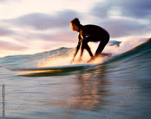 Photography Slow shutter - Longboarder popping up on a smooth wave at sunset - Gold Coast