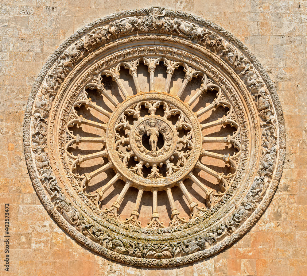 Stony rose window on the western front of the Cathedral Santa Maria Assunta in Ostuni, Italy,