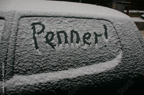 im schnee geschriebene mitteilung auf einer autoscheibe photo