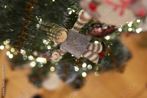 Christmas tree toy on Christmas tree branches and bokeh