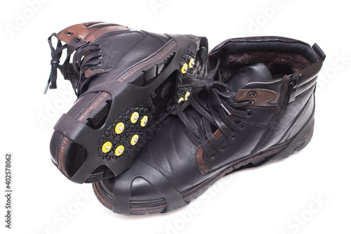 Winter boots with rubber grippers for ice. Accessory with spikes for shoes to prevent slipping in winter season.