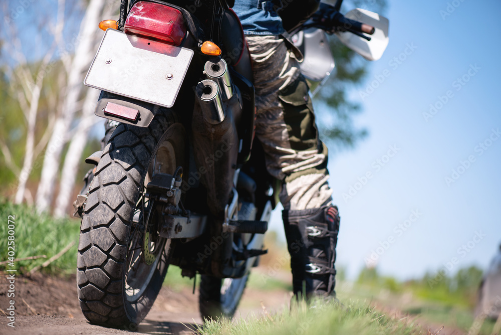 Motor biker on the countryside road close up. Motor biker on the countryside road close up.
