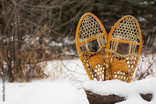 Snowshoes in a heart shape with a snow background, perfect for copyspace.