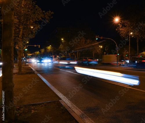 Buses and cars moving at night on the road.