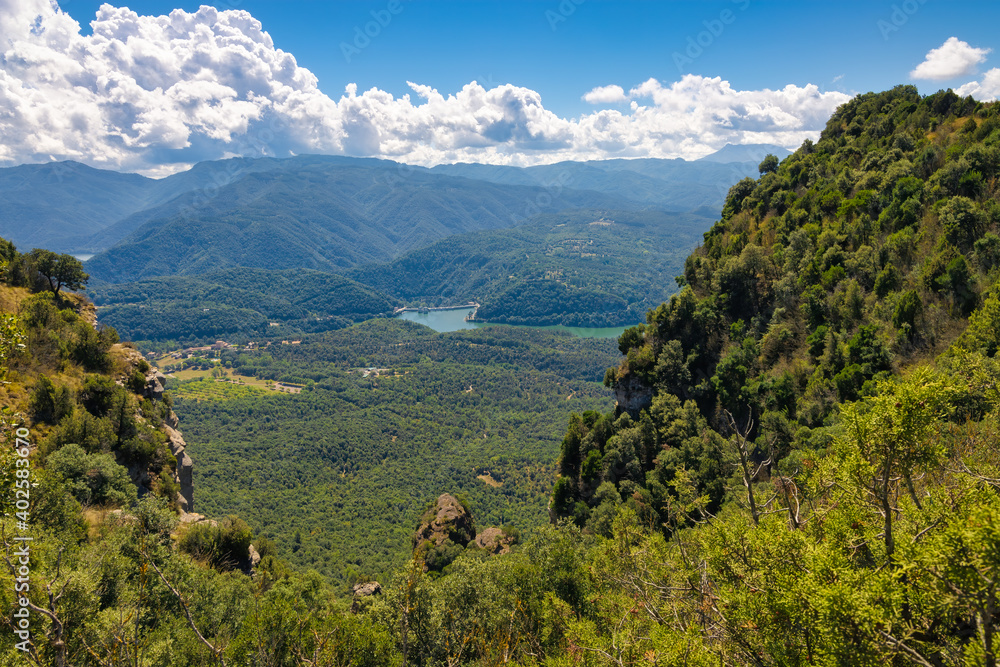 Fototapeta premium Panoramic view from the top of the Collsacabra cliffs of the Sau reservoir dam. Tavertet, Catalonia, Spain
