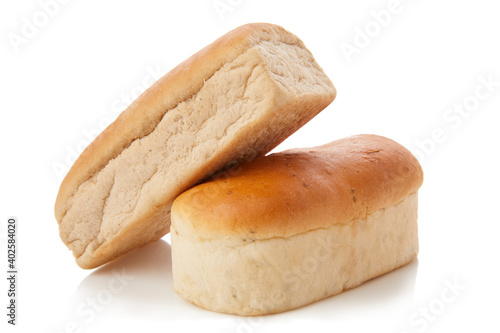 long loaf of whole wheat bread on white background.