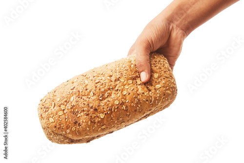 Hand holds a long loaf of bread on white.