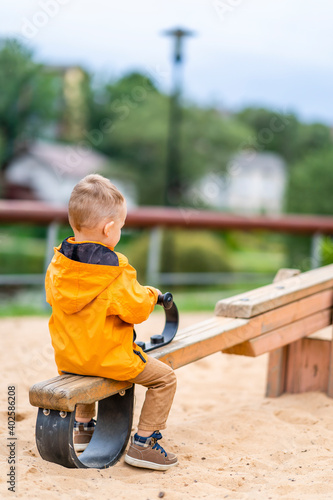 Young Boy on Seesaw Swings in Park