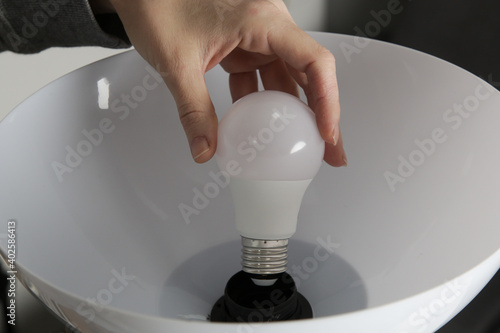 Replacing light bulb at home. Simple DIY housework maintaince.	
 photo