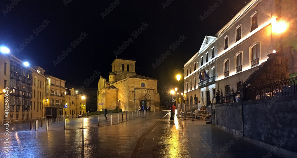 Iglesia de San Juan de Rabanera y fachada de la Diputación Provincial de Soria en la calle Caballeros una noche lluviosa. Soria, España.