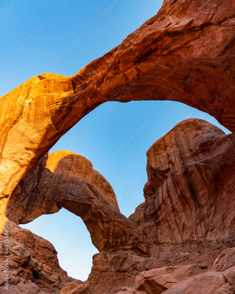 wide shot of two arches in the desert