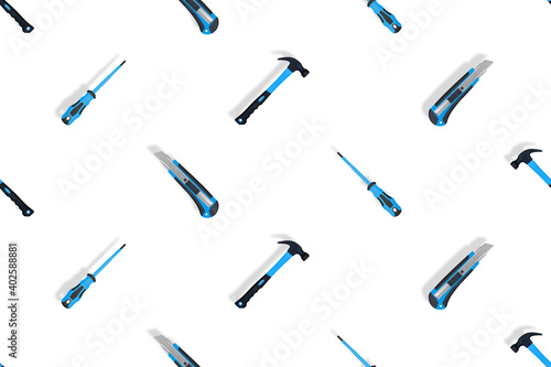 Tools seamless pattern. Tools: hammer, screwdriver and knife on a white background.