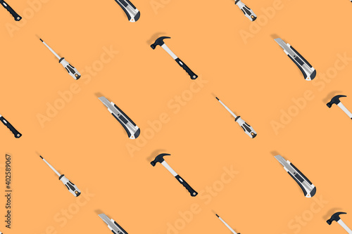 Wallpaper Mural Tools seamless pattern. Tools: hammer, screwdriver and knife on an orange background. Torontodigital.ca