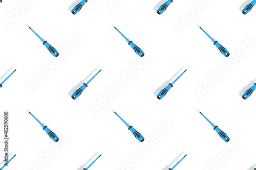 Screwdrivers seamless pattern. Metal screwdrivers with a rubberized handle on a white background.