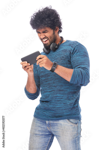 Photography Cheerful young man showing latest smart phone isolated on white.