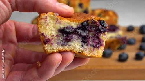 Texture of blueberry muffin close-up. The chef tries a piece of dough.