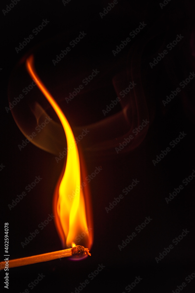 burning match on a dark background burning match on a dark background