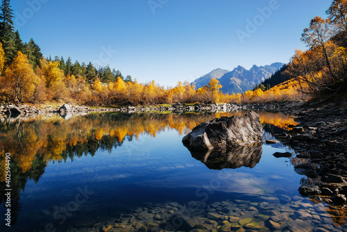 A picturesque lake in the mountains in the autumn season in cloudless weather