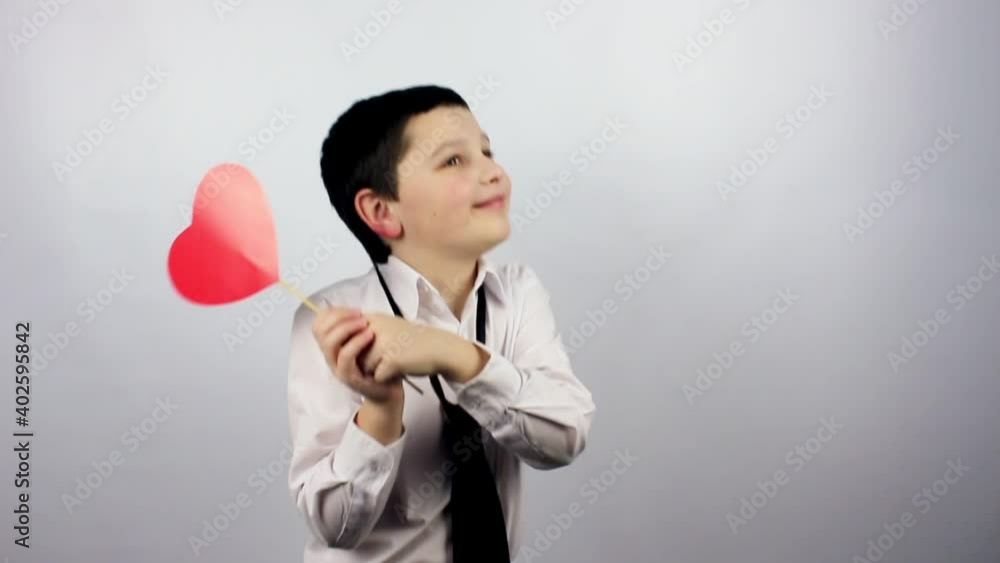 Valentine's Day. Little boy holding a red heart in his hands. Valentine's Day. Celebrate. Valentine's Day. Little boy holding a red heart in his hands. Valentine's Day. Celebrate.