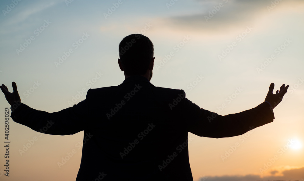 personal achievement goal. man silhouette on sky background. confident businessman with raised hands. daily motivation. enjoying life and nature. business success. freedom