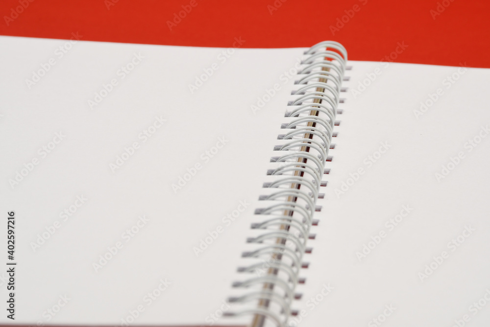 Close-up blank notebook with white papers and white springs. Close-up blank notebook with white papers and white springs.