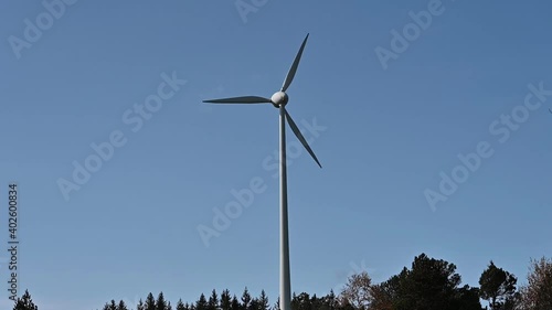 A wind power station in the Black Forest of Germany under a blue sky. photo