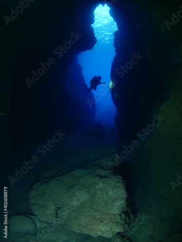 Wallpaper Mural Scuba divers underwater exploring lightcaves blue ocean scenery with torch 
 Torontodigital.ca