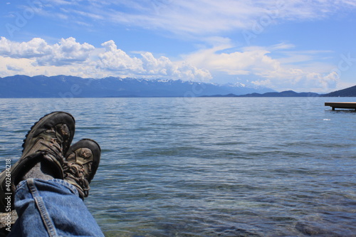 Montana lake with tired hiker resting