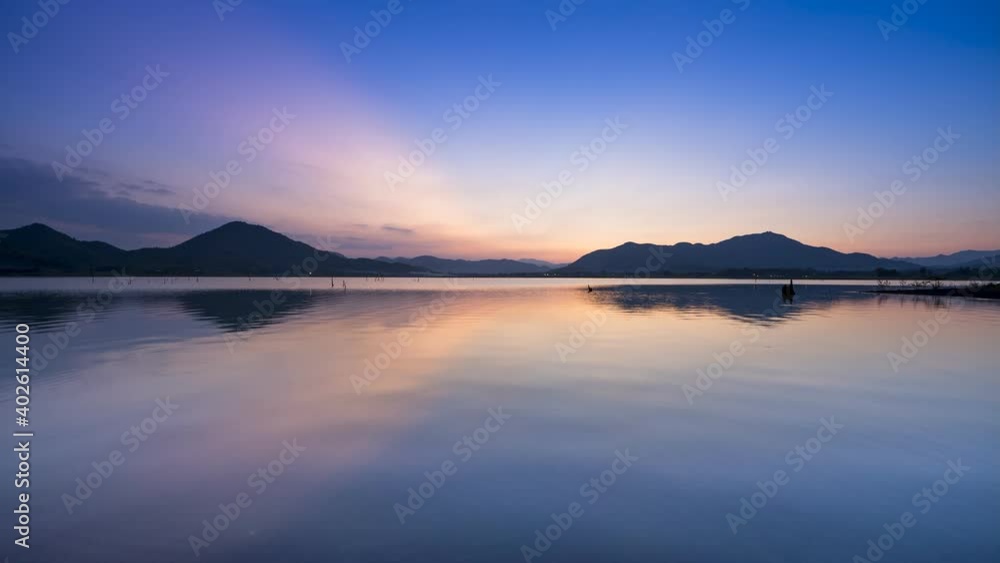 Lake with mountain under cloudy sky at sunset Lake with mountain under cloudy sky at sunset